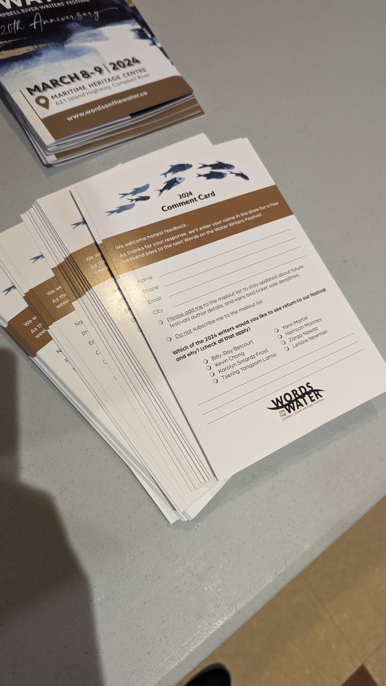 A stack of 2024 comment cards on a gray table. The cards feature fish graphics, event details, and checkboxes for attendee feedback on an event organized by Maritime Heritage Centre.