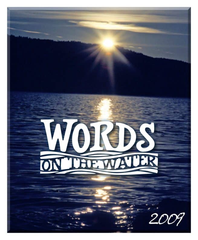 Sunset over a calm lake with a dark treeline. White text reads "WORDS ON THE WATER." "2009" is written in the lower right corner. Sunlight reflects across the water’s surface.